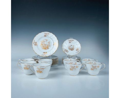 A set of 8 teacups, 8 saucers, and 8 plates in a beautiful white color and painted with gold-colored flower bouquets. Marked 