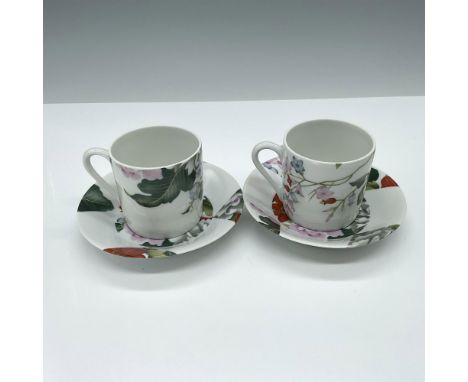 This pair of small cups and matching saucers is decorated in a floral pattern with green, pink, and red coloration. Marked to