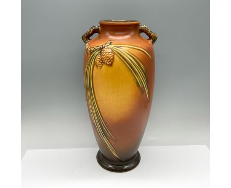 Art pottery table vase depicting the Pine Cone pattern. Decorated with two short handles that imitates a tree branch. Rosevil