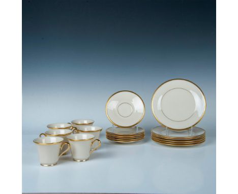 A set of 6 cream-colored teacups, saucers, and plates, adorned with opulent gold accents along their rims. Lenox backstamp. M