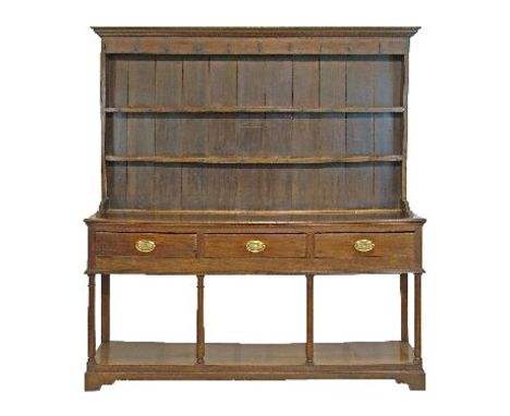 George III oak dresser, the plate rack fitted two shelves, the base fitted three drawers to the frieze and standing on tapere