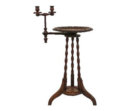 Late 19th/early 20th Century walnut and beech sewing table, the circular top having a carved border, adjustable two branch ca