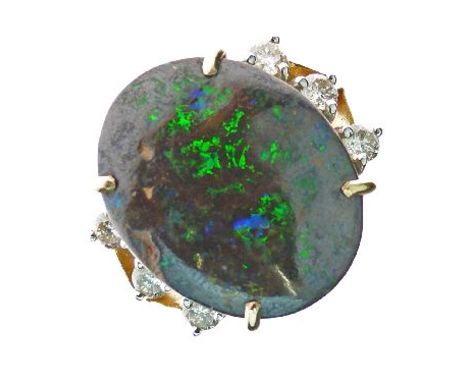 Boulder opal and diamond ring, stamped '750', the oval shallow cabochon 18.3mm x 14.7mm x 5.3mm deep, with a trio of brillian