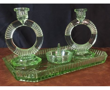 An exquisite uranium glass set, featuring two circular candlesticks, a ring holder, and a tray, crafted in the classic Art De