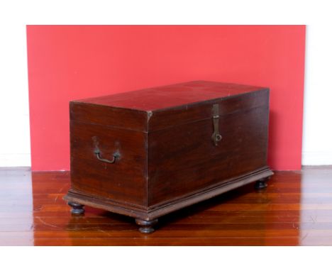 A COLONIAL HARDWOOD TRUNK ON STAND
With hinged cover, twin carrying handles, raised on plinth base with bun feet
49 high x 43