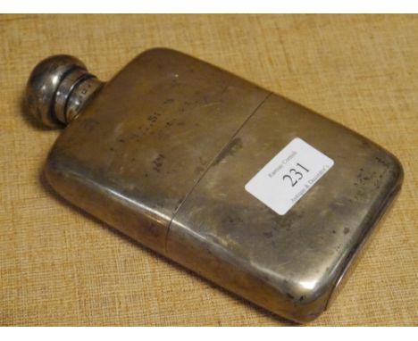 A George V silver hip flask and cup, W &amp; G Neal, London 1910, shaped for the hand, with pull-off gilt lined cup, engraved