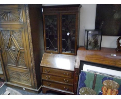 A small George III style inlaid mahogany bureau bookcase, c. 1900, with moulded cornice above a pair of astragal glazed doors