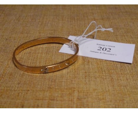 A 15ct gold "buckle" bangle. 9.9 grams