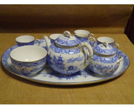 A Royal Worcester porcelain cabaret set in the Willow pattern, factory mark for 1902, comprising oval tray, teapot, cream, su