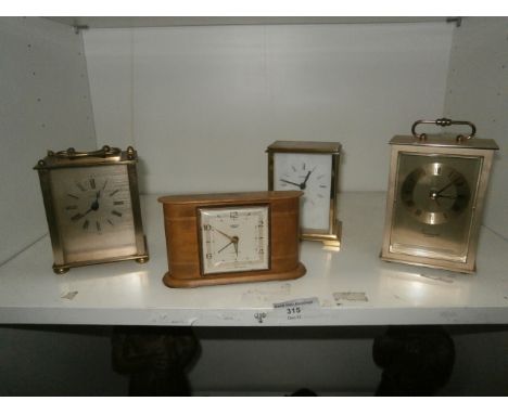 shelf of carriage clocks and a small smiths clock