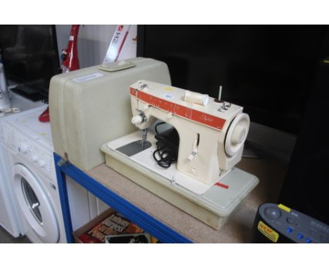 A Singer electric sewing machine in carrying case sold as collectors item