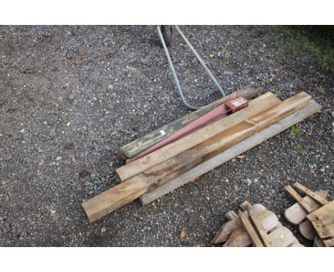 A quantity of timber and a metal post