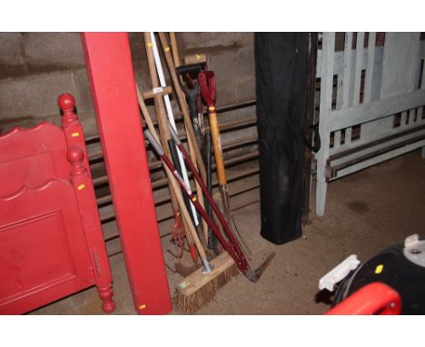 A quantity of long handled garden tools