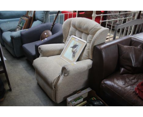 A button back upholstered reclining wing back armchair