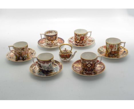 Six Royal Crown Derby Curators Collection coffee cans and saucers together with a miniature teapot