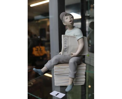 Nao figure of a Paperboy seated on stack of papers. 23cm in Height 