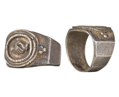 Ca. 100-300 ADA solid silver ring composed of a wide, D-shaped, facetted hoop; raised oval-shaped frame with 'dextrarum iunct