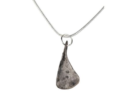 Ca. 700-900 ADA beautiful silver pendant with an integral loop shaped like a bearded Viking axe head.For more information on 