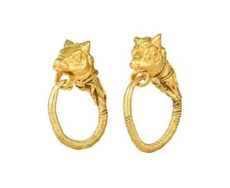 Ca. 300-100 BCA matching pair of gold earrings, formed as loops of twisted shanks expanding to a collared bull head finials o