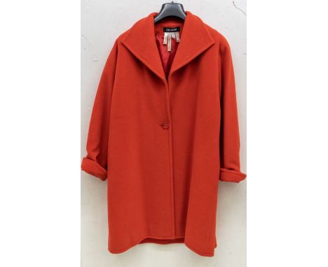 A tomato red cashmere coat by Jean Muir. 1980s to 90s. Size 10, full length, with one glass button fastening. It has a stitch