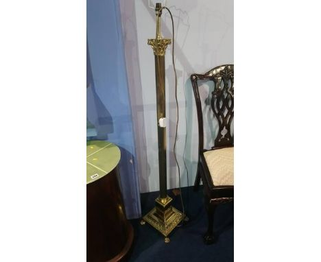 A brass Corinthian column standard lamp and a pair of table lamps