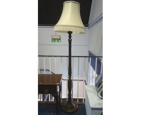 A carved standard lamp