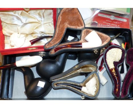 A collection of meerschaum pipes with carved portrait bowls