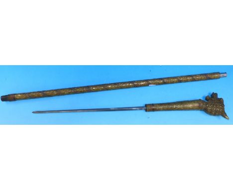 An oriental brass cased sword stick with extensive embossed leaf decoration and dragon head handle
