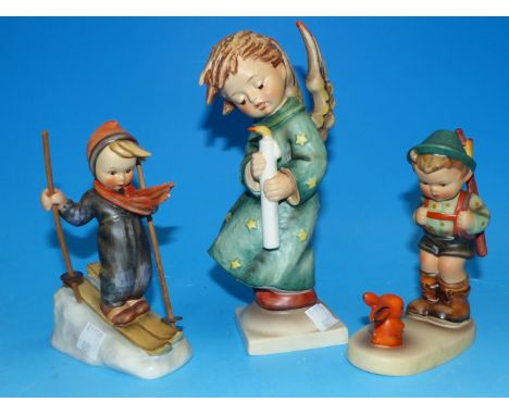 A large Hummel figure by Goebel of an angel, 7"; a girl skier with wood poles; a boy hunter with rabbit
