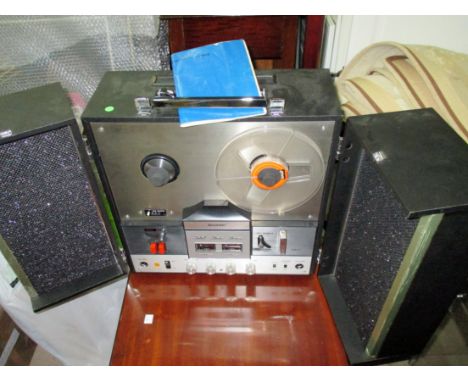 A Sharp reel to reel recorder with stereo speakers