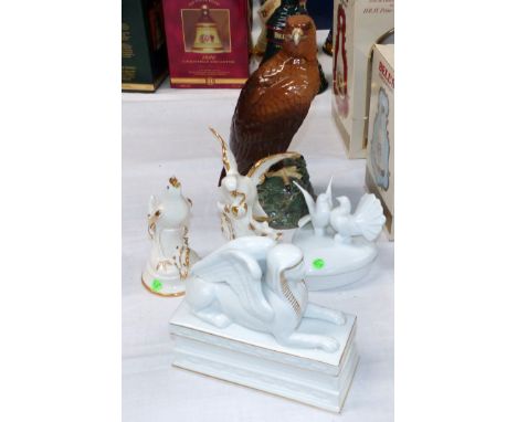 A Whyte & Mackay Golden Eagle decanter with contents, by Royal Doulton; other china animals; etc.