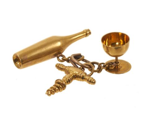 Antique French gold novelty charm in the form a wine bottle, corkscrew and goblet, French eagle's head hallmarks.4.7 grams