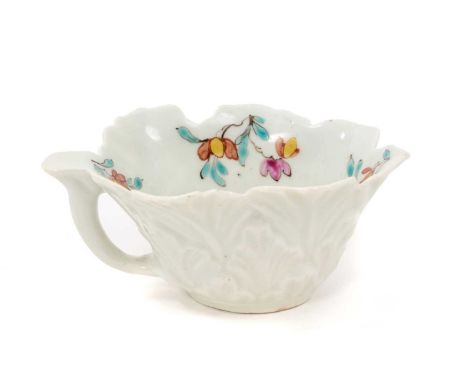 A rare Worcester polychrome leaf-shaped butterboat, circa 1758, with branch handle, painted to the well with scattered polych