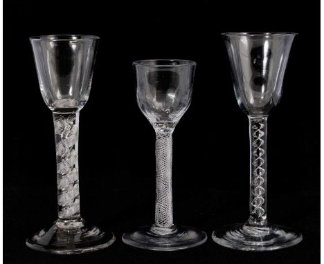 Three air twist wine glasses, circa 1750,  including one with a round funnel bowl above a mercury twist stem, one with a moul