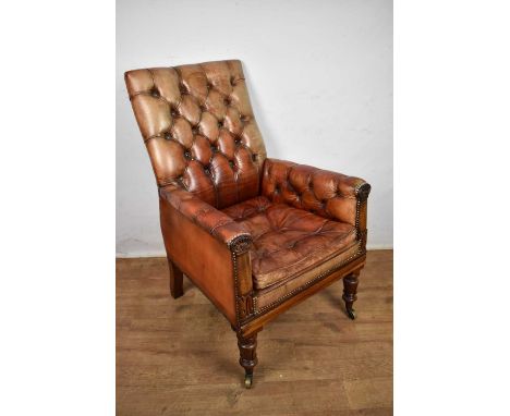 Good William IV button leather upholstered library chair, with square back and seat, in lappet carved mahogany showwood frame