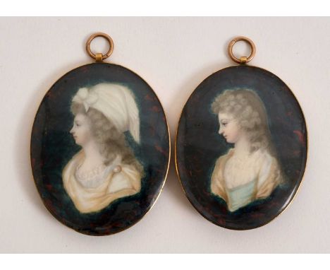 Near pair of 18th century portrait miniatures on ivory, each depicting a young woman in profile within unusual faux marble ba