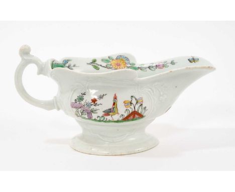 An early Worcester moulded sauceboat, circa 1753-54, finely painted in polychrome enamels with birds amongst trees and rockwo