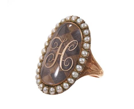 George III gold and seed pearl mourning ring with a large oval glazed bezel containing a finely woven hair chequered panel su