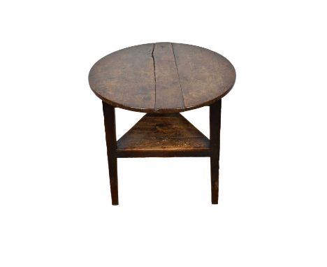 18th century oak cricket table, with circular top and triangular shelf below on tapered gently splayed supports, 62cm diamete