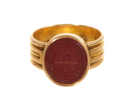Victorian 18ct gold and intaglio carved carnelian signet ring, the oval seal with family crest and motto, in gold setting wit