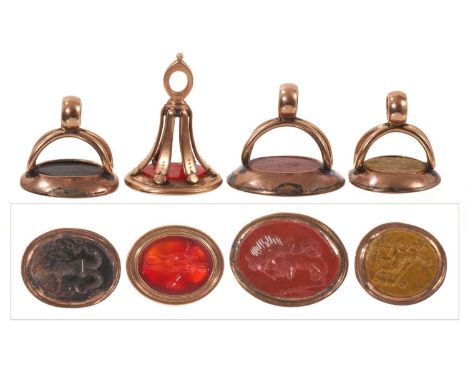 Four Georgian gold mounted seals, each containing an intaglio carved stone depicting Roman subjects, the largest 24mm high.Al