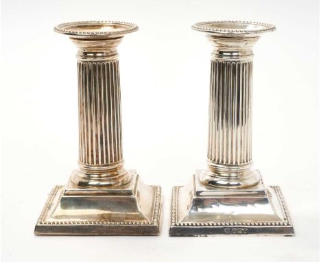 Pair of late Victorian candlesticks, with fluted columns, on square bases with bead borders, separate sconces (Sheffield 1899