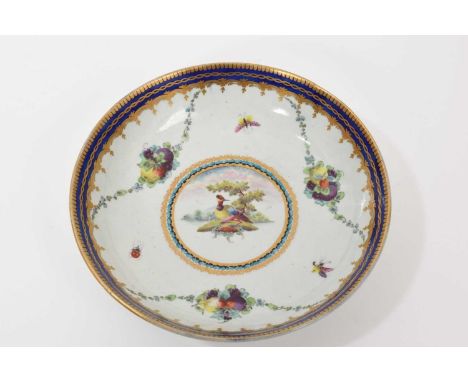 A Worcester 'Lord Rodney' type saucer dish, circa 1770, painted with a colourful bird, swags of fruit and insects, with gilde