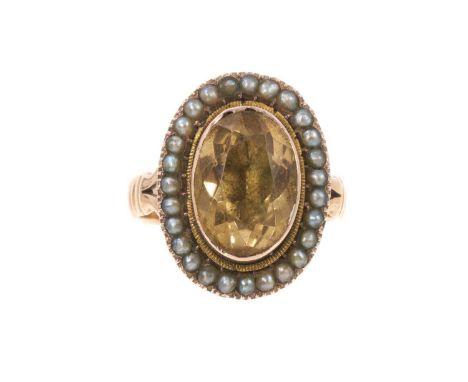 Antique citrine and seed pearl cluster ring with an oval mixed cut citrine in foil-backed gold collet setting surrounded by a