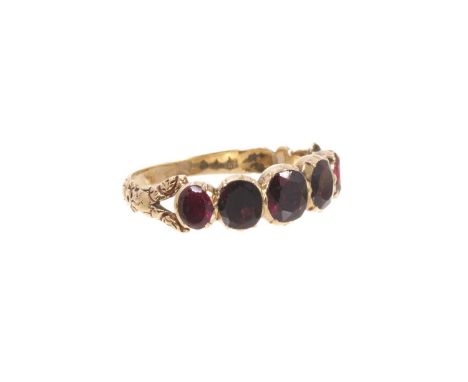 Georgian garnet five stone ring with five oval mixed cut garnets in foil-backed gold collet setting, bifurcated foliate shoul