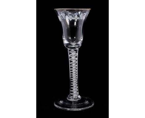 A Beilby opaque twist wine glasses, circa 1765, the bell bowl decorated with gilded rim and a floral garland in white enamel,