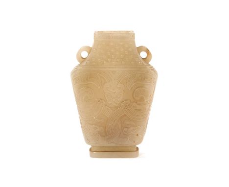Chinese jade or green hardstone miniature vase, flattened baluster form with twin handles, with twin handles, carved in low r