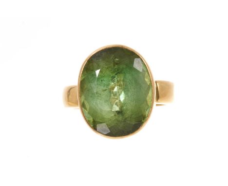 Green tourmaline ring with an oval mixed cut tourmaline, measuring approximately 16.5mm x 13.4mm x 10.1mm, in an 18ct gold se