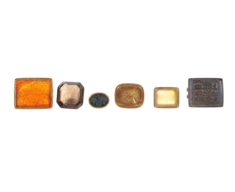 A group of six antique seals, all with Eastern script, to include finely carved intaglio stones, some with gold mounts. (6)