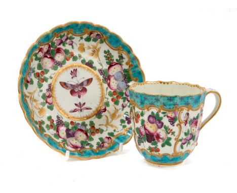 An unusual Worcester fluted porcelain cup and saucer, circa 1770, painted in enamels with fruit and insects, with gilt and tu
